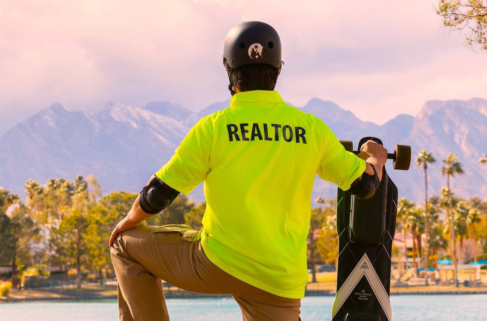 Photo of Real Estate Agent Tony Ranaudo in front of a lake with his skateboard who is a writer for AskRealtorTony.com